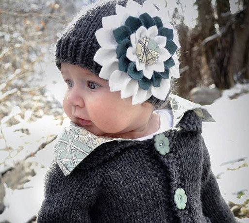 Tutorial to make a DIY felt flower--perfect for accenting a baby hat or headband. | MakeAndDoCrew.com