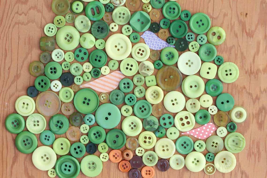 This DIY button art project looks great in a baby's room or nursery, especially as part of a gallery wall. Free printable template to make your own. Click for the full tutorial. | MakeAndDoCrew.com