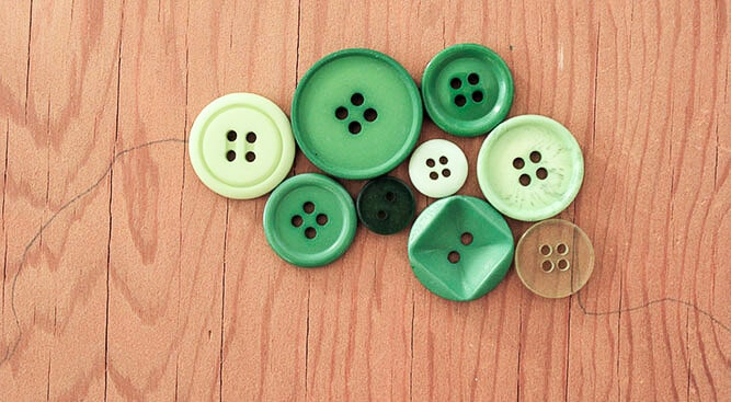 This DIY button art project looks great in a baby's room or nursery, especially as part of a gallery wall. Free printable template to make your own. Click for the full tutorial. | MakeAndDoCrew.com