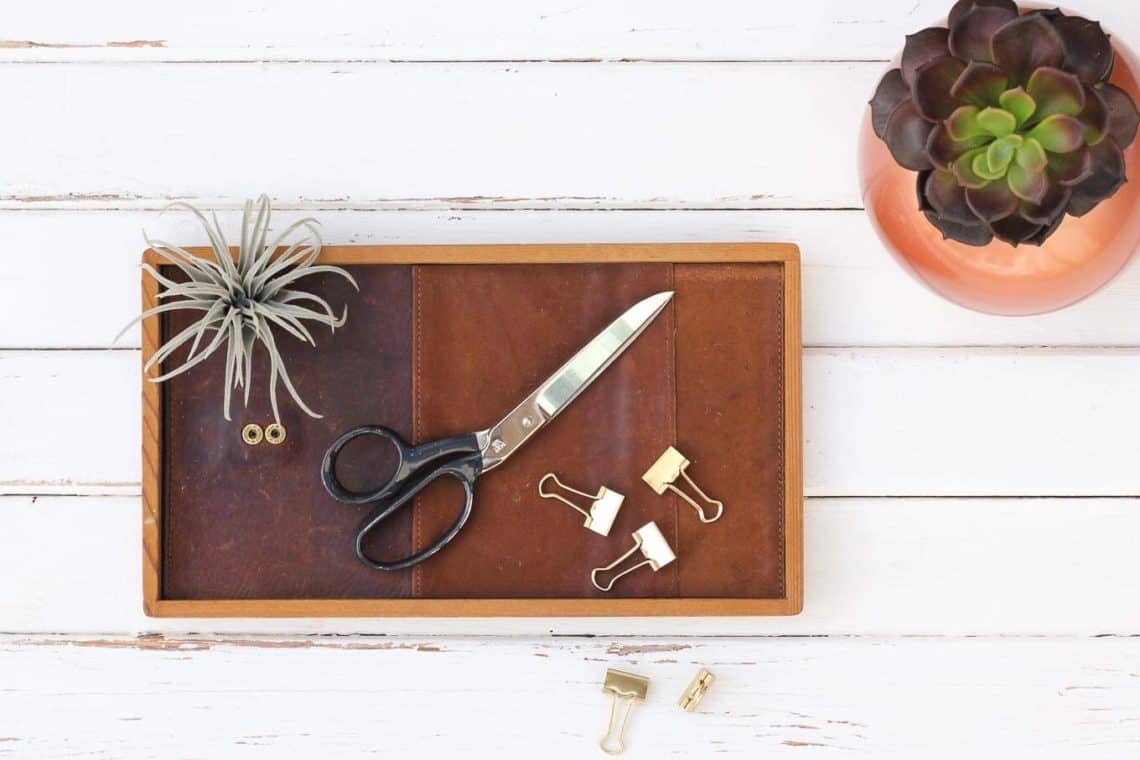 All you need for this inexpensive DIY gift for him is a thrifted leather wallet and a wood tray. This leather catchall tray makes a perfect DIY Father's Day gift idea, a quick Christmas craft for the man in your life or a third anniversary leather gift. | MakeAndDoCrew.com