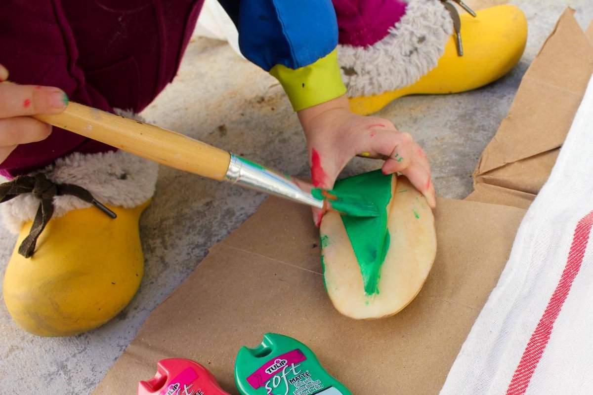 Potato stamp tea towel craft--a perfect DIY Christmas gift idea to make a bunch of at one time. They work out to about $1 each, which makes them an easy, inexpensive gift for everyone. This is a craft project parents can do with kids too! Click to view full step by step tutorial. | MakeAndDoCrew.com