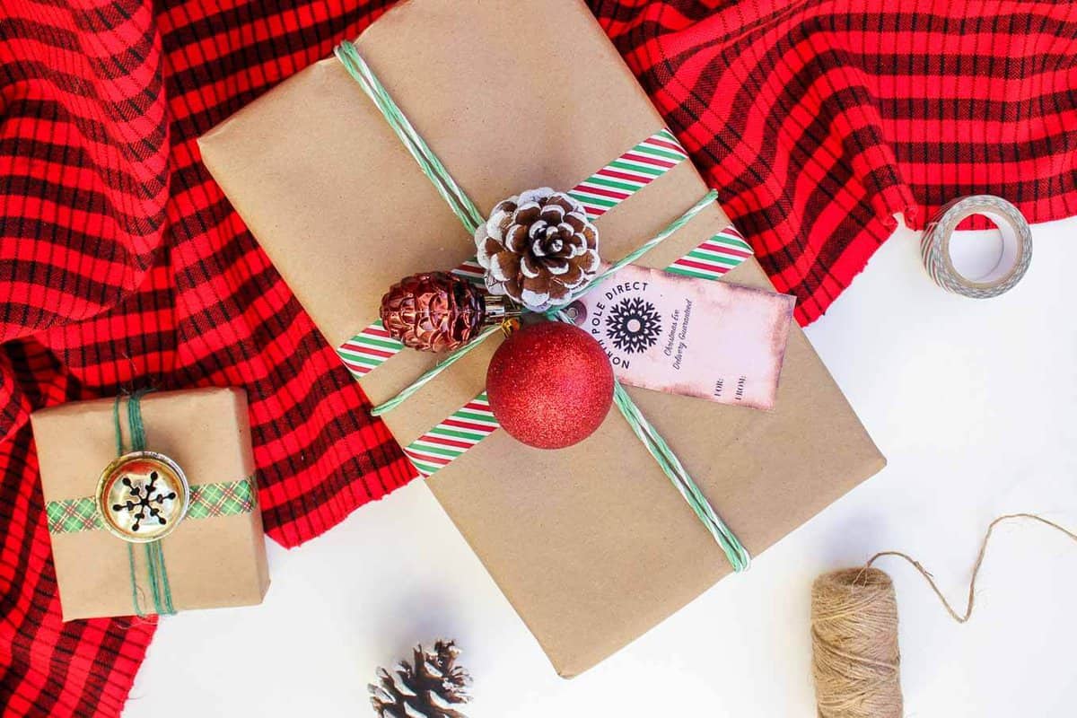 Christmas DIY gift wrap ideas with supplies from the dollar store. These gift topper ideas are sophisticated, festive and cheap! Click to see full tutorial. | MakeAndDoCrew.com