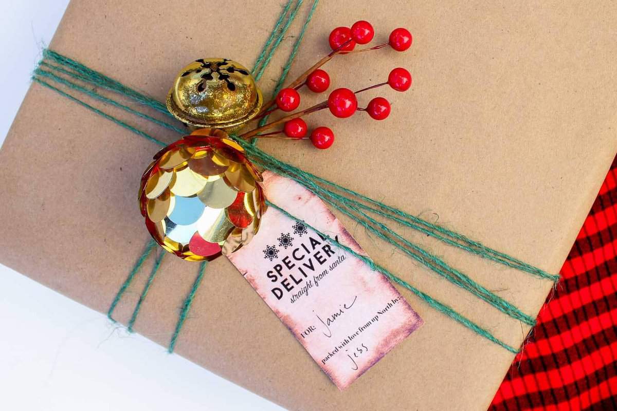 Christmas DIY gift wrap ideas with supplies from the dollar store. These gift topper ideas are sophisticated, festive and cheap! Click to see full tutorial. | MakeAndDoCrew.com