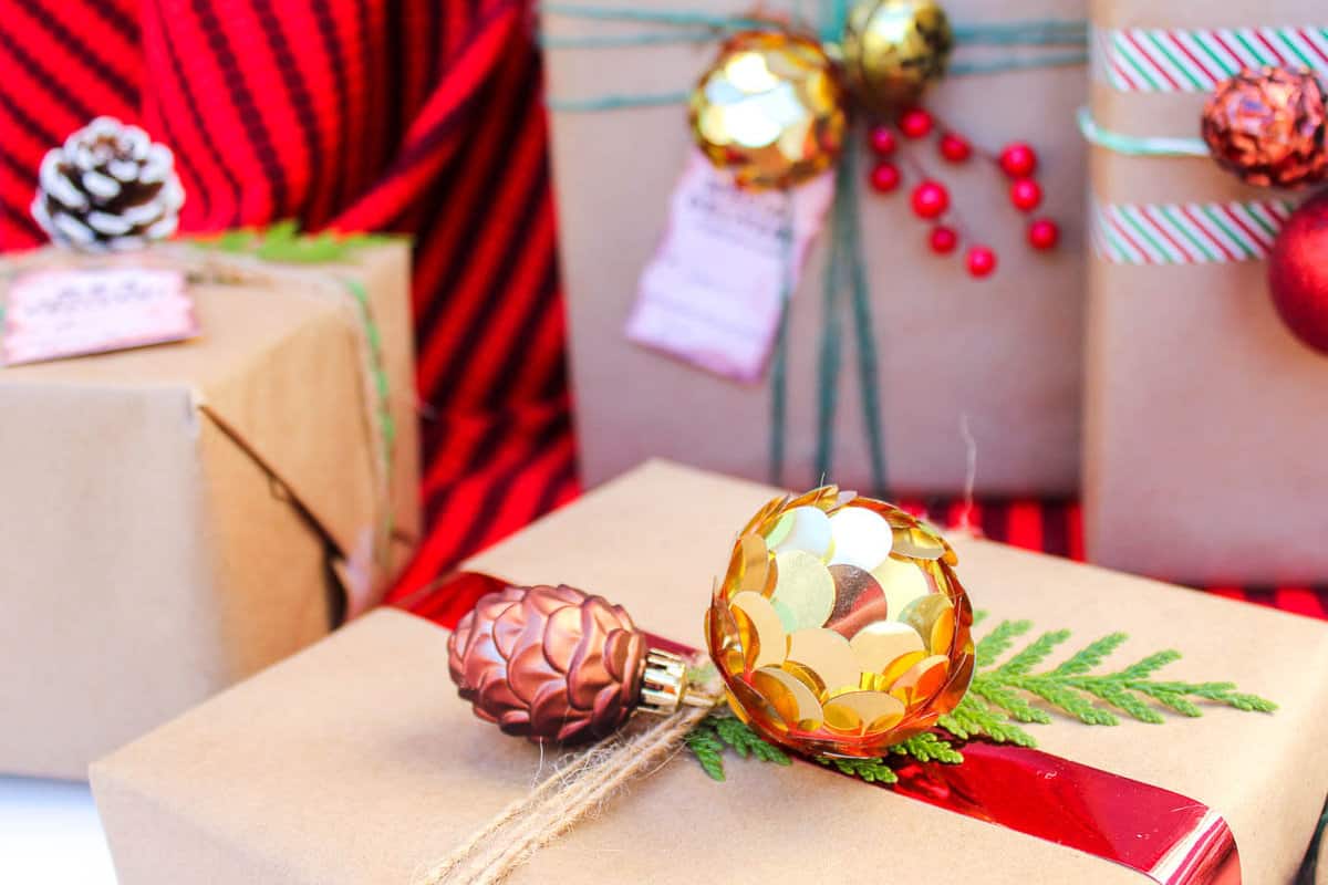 Christmas DIY gift wrap ideas with supplies from the dollar store. These gift topper ideas are sophisticated, festive and cheap! Click to see full tutorial. | MakeAndDoCrew.com