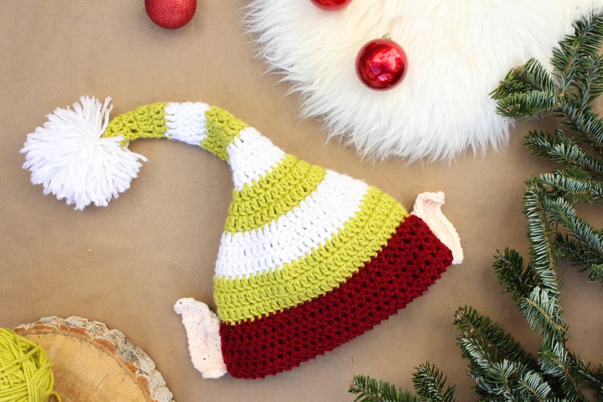 Free crochet elf hat pattern with ears! Make one for each member of the family. Perfect Christmas photo prop idea. Free pattern sizes include 0-3 months (newboarn), 3-6 months (baby), 6-12 months, toddler/preschooler, child and adult. Click to see full pattern. | MakeAndDoCrew.com