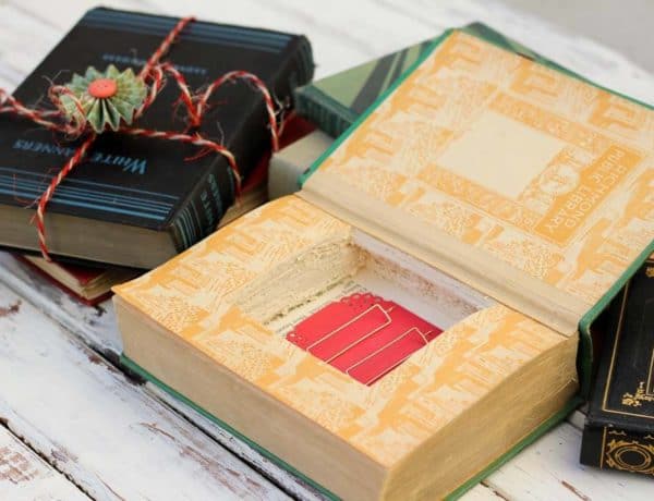 Turn an old vintage book into an keepsake DIY gift box with this simple tutorial. These gift boxes are a creative DIY ring bearer pillow alternative, too! Perfect gift wrap idea for gifts for him, weddings, bridesmaids, Christmas, Valentine's day and a book-lover's birthday. | MakeAndDoCrew.com