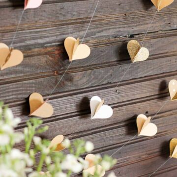This handmade paper heart garland also adds beautiful texture and a hint of charm as a wedding photo booth backdrop. It makes a super sweet DIY Valentine's Day decor idea. Bonus: easy craft project to use up your scrapbooking paper scraps! Click to view full tutorial. | MakeAndDoCrew.com