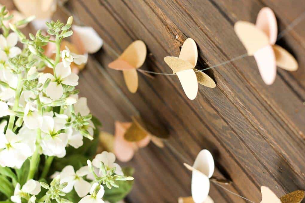 This handmade paper heart garland also adds beautiful texture and a hint of charm as a wedding photo booth backdrop. It makes a super sweet DIY Valentine's Day decor idea. Bonus: easy craft project to use up your scrapbooking paper scraps! Click to view full tutorial. | MakeAndDoCrew.com