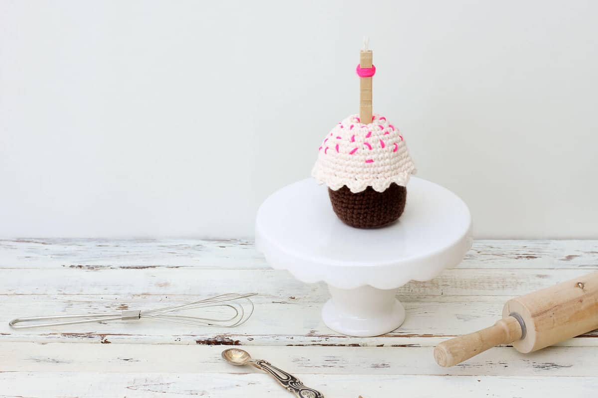 This free amigurumi crochet cupcake pattern makes a perfect DIY gift idea for a toddler or child. The birthday candle adds even more possibilities for play to this sweet toy. Or make it for a friend or co-worker when you need a calorie-free birthday gift! | MakeAndDoCrew.com