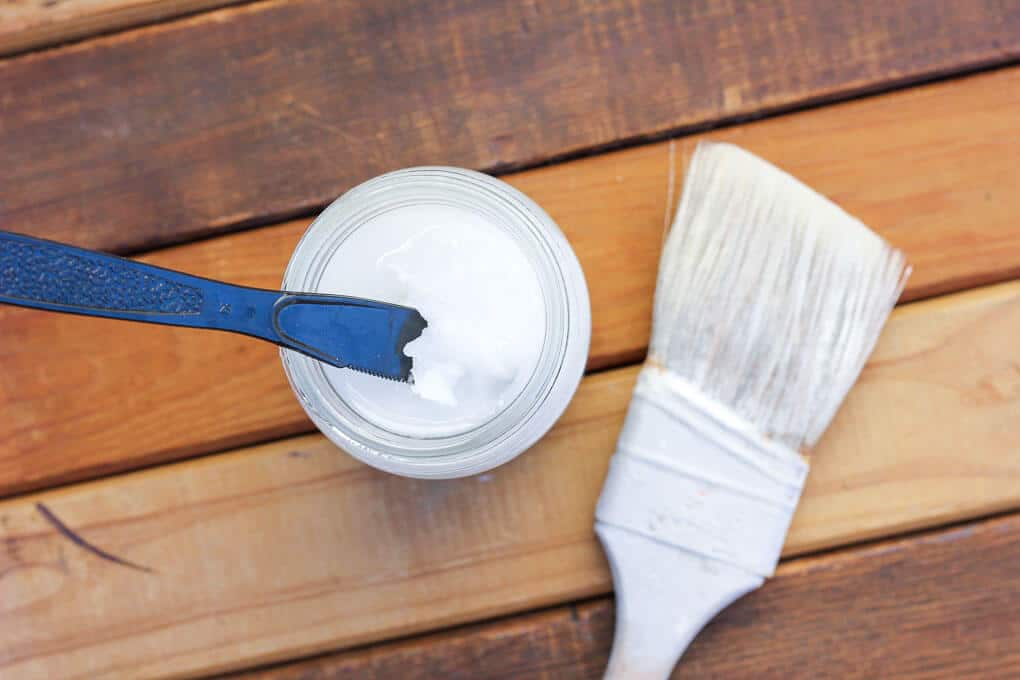 A simple tutorial that shows you how to distress wood with paint and coconut oil. This technique is similar to using Vaseline to make your paint look weathered, distressed and shabby chic. Click for the step by step. I used it to make a blog photography backdrop. | MakeAndDoCrew.com
