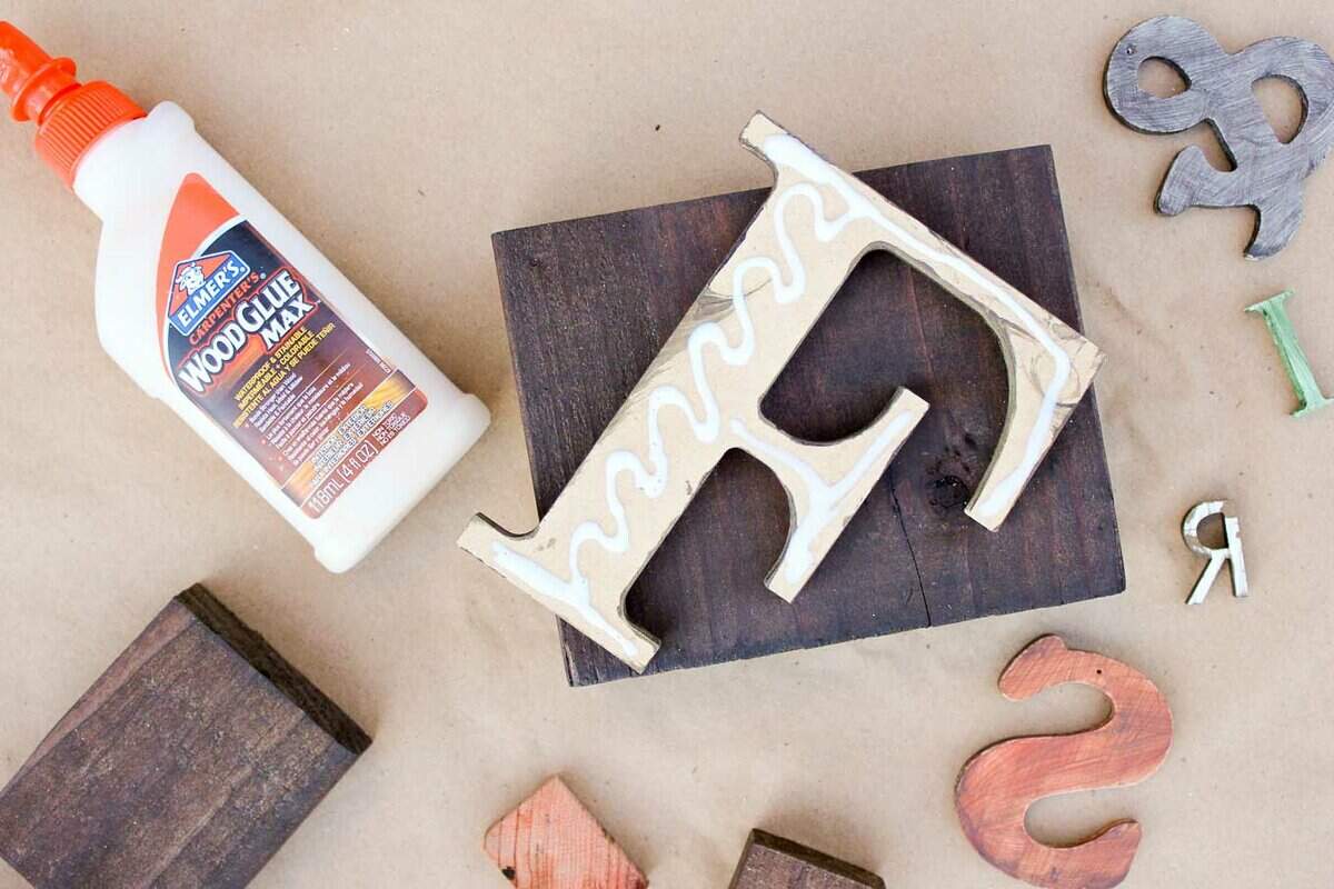 A DIY wall art idea that uses wooden letters (from any craft store) to make faux letterpress printing blocks. The vintage typography look adds so much charm to any room! Click for the full step-by-step tutorial. | MakeAndDoCrew.com