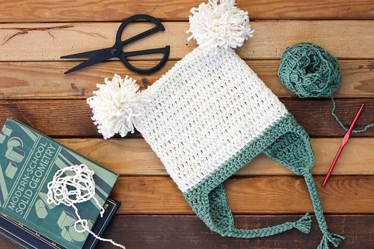 This free crochet beanie pattern is perfect for beginners because the skills involved aren't much harder than making a scarf. Free pom pom hat pattern in sizes baby (newborn), 3-6 months, 6-12 months, toddler/preschooler, child, teen/adult. | MakeAndDoCrew.com