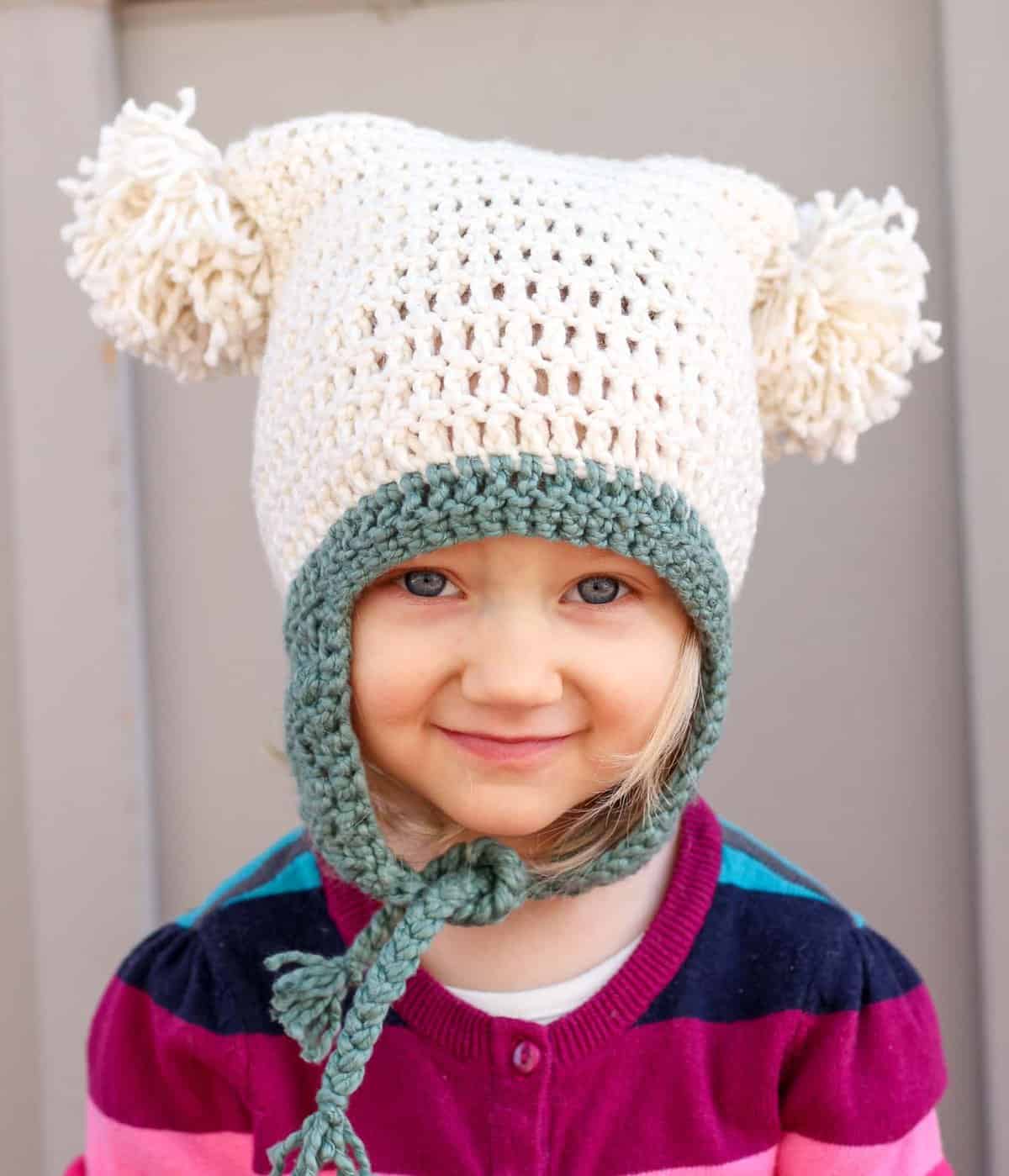 This free crochet beanie pattern is perfect for beginners because the skills involved aren't much harder than making a scarf. Free pom pom hat pattern in sizes baby (newborn), 3-6 months, 6-12 months, toddler/preschooler, child, teen/adult. | MakeAndDoCrew.com