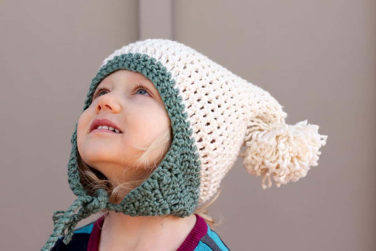 This free crochet beanie pattern is perfect for beginners because the skills involved aren't much harder than making a scarf. Free pom pom hat pattern in sizes baby (newborn), 3-6 months, 6-12 months, toddler/preschooler, child, teen/adult. | MakeAndDoCrew.com