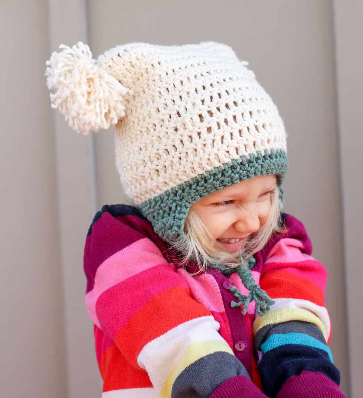 This free crochet beanie pattern is perfect for beginners because the skills involved aren't much harder than making a scarf. Free pom pom hat pattern in sizes baby (newborn), 3-6 months, 6-12 months, toddler/preschooler, child, teen/adult. | MakeAndDoCrew.com