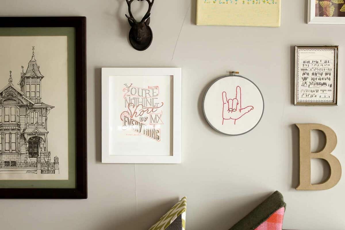 This free embroidery pattern is based on the American Sign Language sign for "I love you." Perfect DIY art for a baby nursery, playroom or Valentine's Day gift idea. Download the design at MakeAndDoCrew.com.