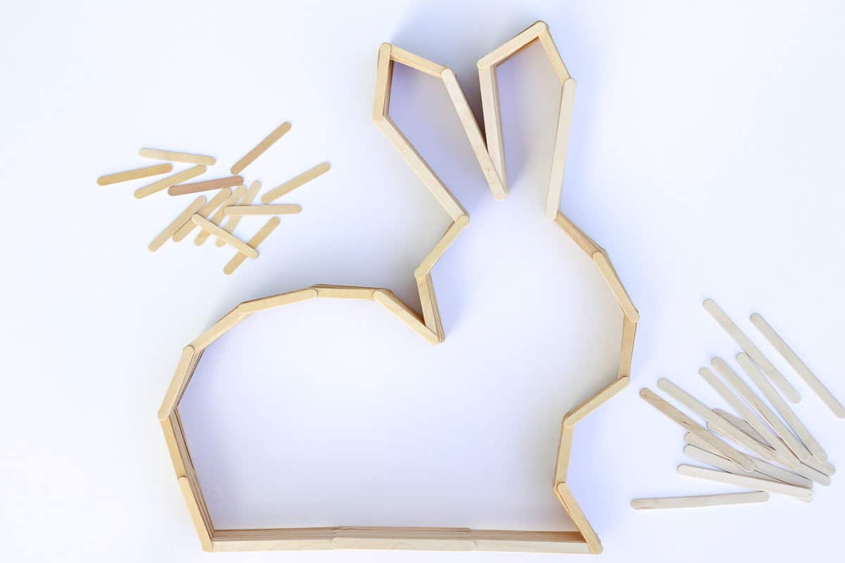 This bunny shelf makes a perfect Easter craft idea for Spring or DIY nursery decor to enjoy year round! Make it out of popsicle sticks using the free downloadable template. Click to see the full tutorial. | MakeAndDoCrew.com
