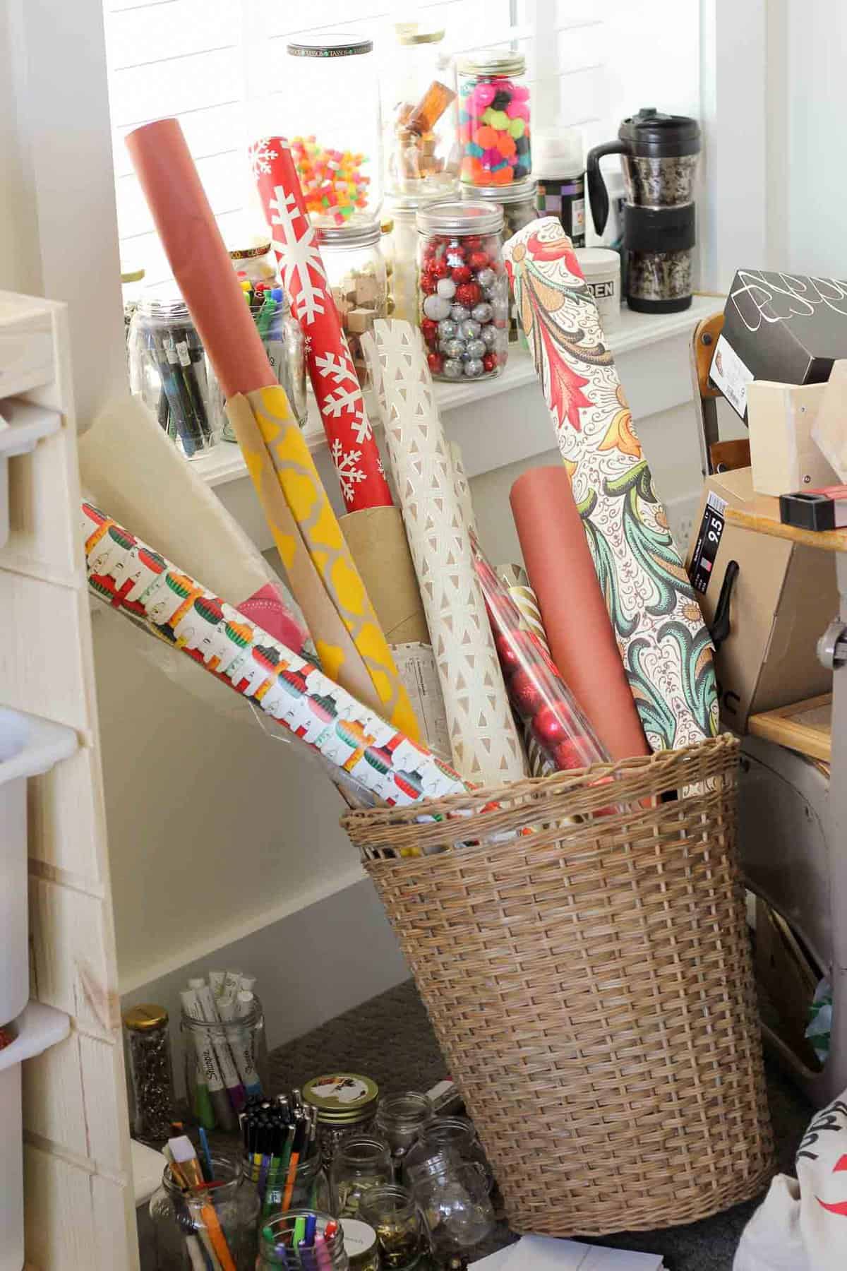 Create simple DIY wrapping paper storage idea using Ikea's Variera plastic bag dispensers. Get those crazy rolls of gift wrap up off the floor and contained in a tidy system! Click for details on measuring and hanging. | MakeAndDoCrew.com