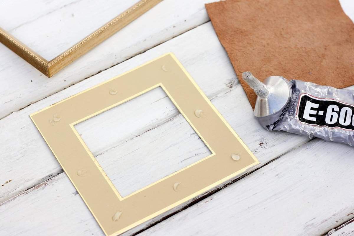 Anything can become a DIY wall decor idea with a little glue and creativity. This matchbook and vintage spool add charming dimension to the gallery wall in this craft room. And this DIY art cost less than a dollar to make! Click to view the tutorial. | MakeAndDoCrew.com