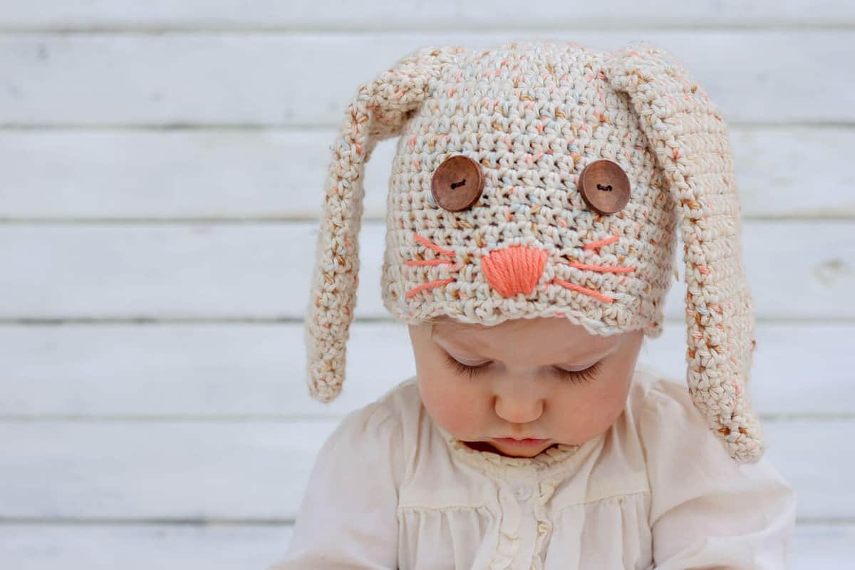 This free crochet bunny hat pattern makes a darling DIY Easter gift for your favorite baby or toddler. Sizes newborn, 3-6 months, 6-12 months, toddler/preschooler. Pair with our free crochet carrot baby toy pattern. Click for free pattern. | MakeAndDoCrew.com