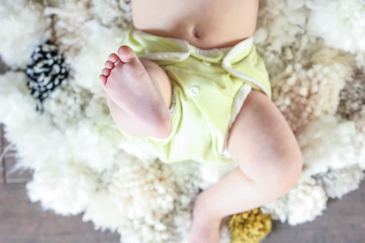 How to make a pom pom rug! This soft, scrumptiously squishy DIY pom pom baby nursery rug takes very few skills to create and is a great way to use up a bunch of scrap yarn! Click for full tutorial. | MakeAndDoCrew.com