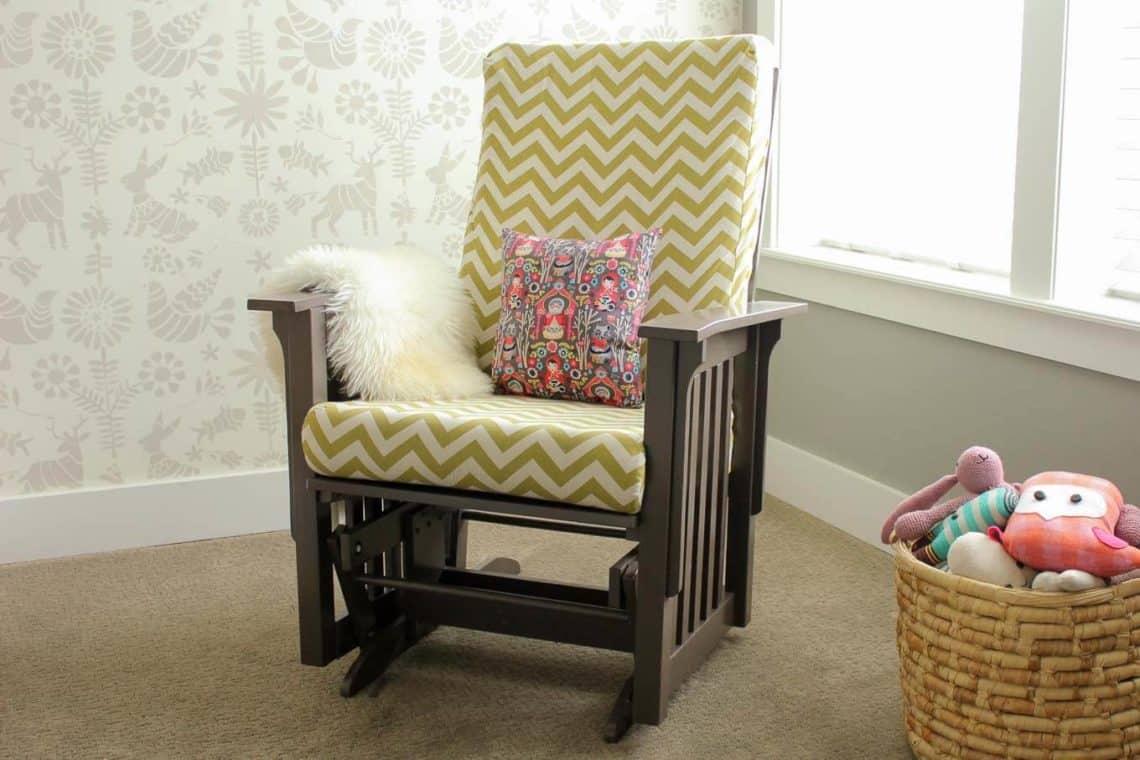 Super thorough tutorial on how to recover a glider chair for a baby's nursery. Instructions on sewing replacement slipcovers and painting the chair. Click to learn how to DIY your own glider makeover. | MakeAndDoCrew.com
