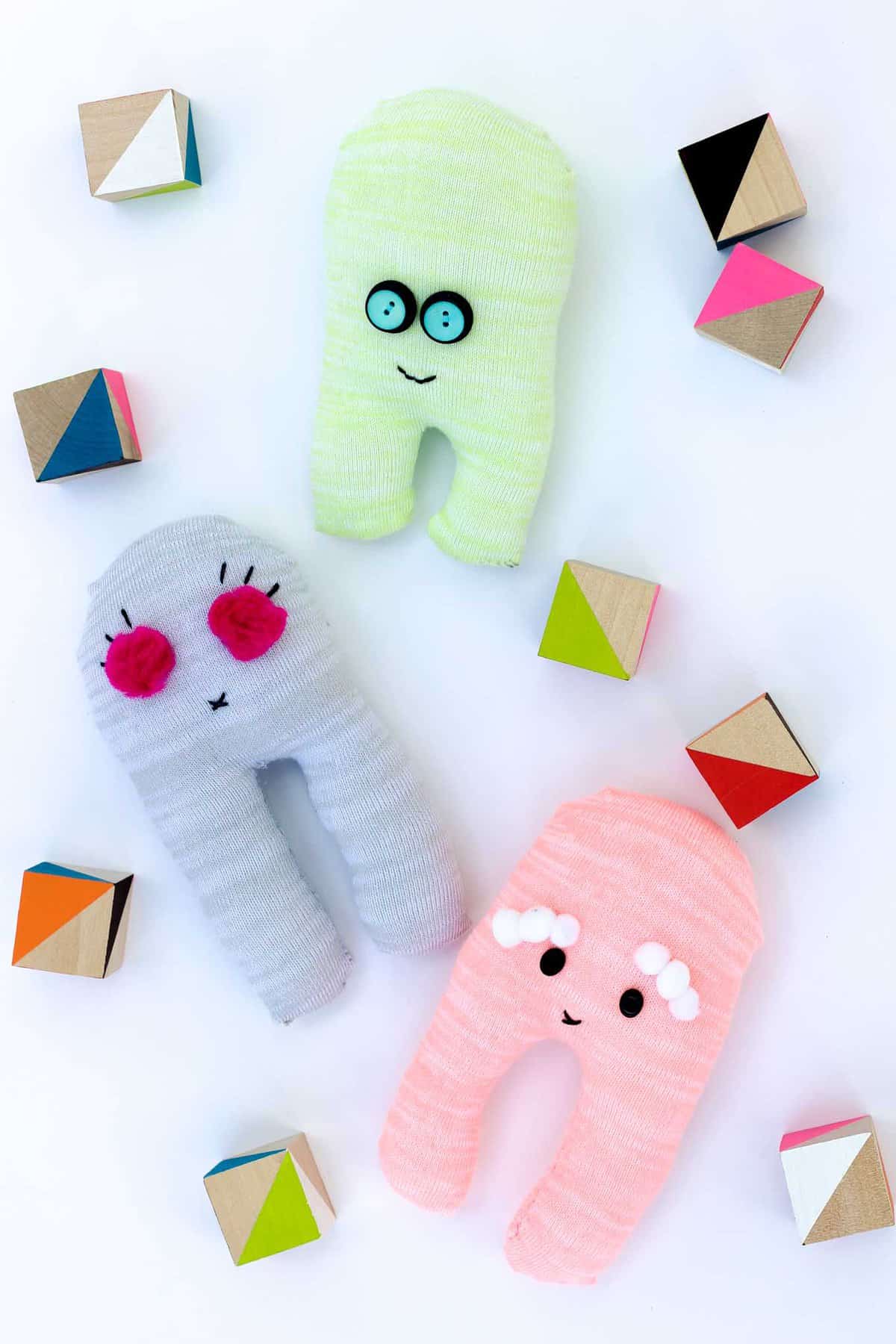 These easy sock robots are a perfect beginner sewing project because they only require a few basic hand sewing skills. Plus, they're a great activity to help teach kids how to sew. | MakeAndDoCrew.com