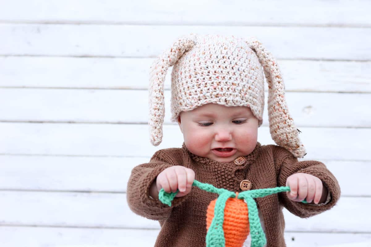 Free amigurumi carrot toy rattle pattern! This free crochet baby toy pattern makes a perfect DIY baby shower gift or Easter basket surprise, especially when paired with our free crochet bunny hat. | MakeAndDoCrew.com