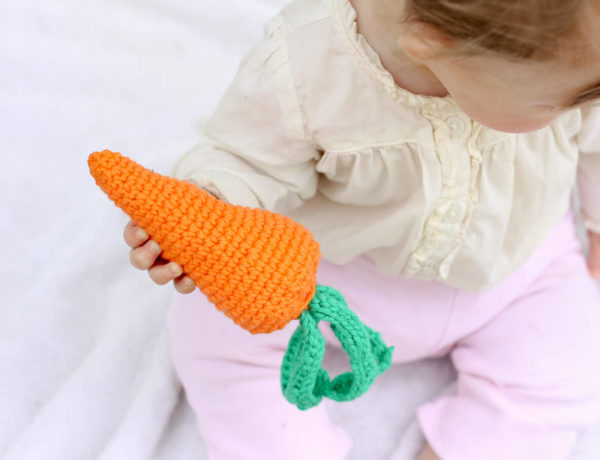 Free amigurumi carrot toy rattle pattern! This free crochet baby toy pattern makes a perfect DIY baby shower gift or Easter basket surprise, especially when paired with our free crochet bunny hat. | MakeAndDoCrew.com
