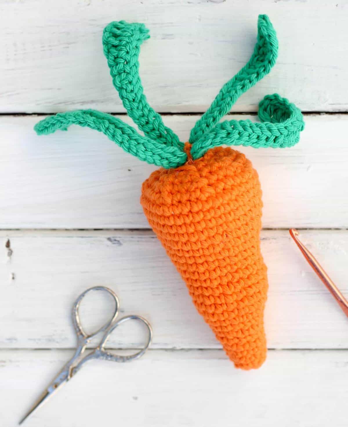 Free amigurumi carrot toy rattle pattern! This free crochet baby toy pattern makes a perfect DIY baby shower gift or Easter basket surprise, especially when paired with our free crochet bunny hat. | MakeAndDoCrew.com