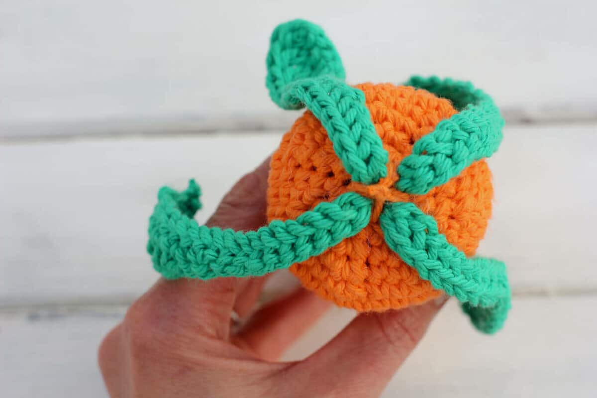 Free amigurumi carrot toy rattle pattern! This free crochet baby toy pattern makes a perfect DIY baby shower gift or Easter basket surprise, especially when paired with our free crochet bunny hat. | MakeAndDoCrew.com