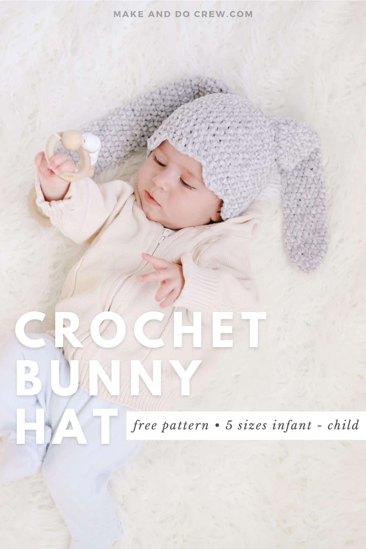 A infant wearing a velour crochet bunny hat with long floppy ears.