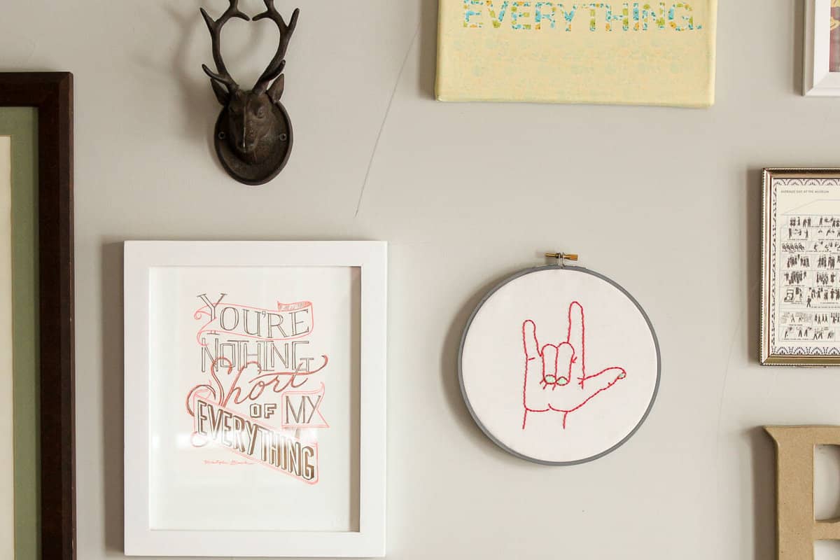 This free embroidery pattern is based on the American Sign Language sign for "I love you." Perfect DIY nursery decor idea or Valentine's Day gift idea. Download the design at MakeAndDoCrew.com.