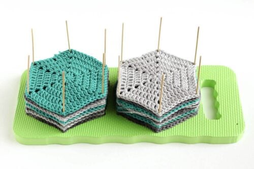 DIY crochet and knit blocking board with hexagons drying on top of it.