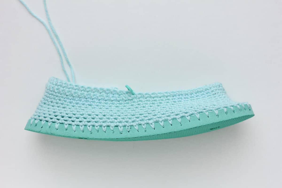 Cotton yarn and a flip flop sole make this free crochet slippers / house shoes pattern perfect for warmer weather. Click to get the full pattern. | MakeAndDoCrew.com