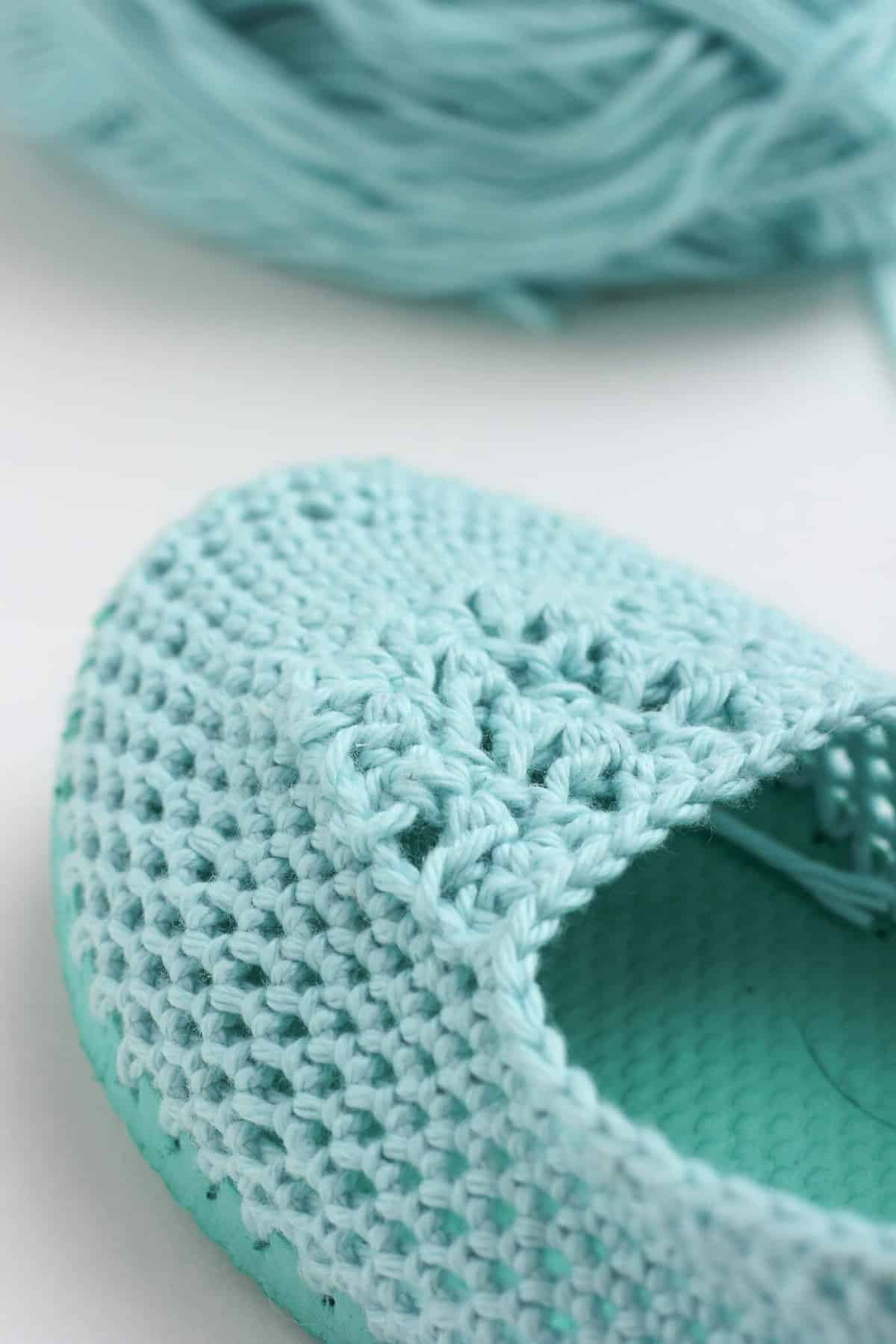 Cotton yarn and a flip flop sole make this free crochet slippers pattern perfect for warmer weather. Click to get the full pattern. | MakeAndDoCrew.com