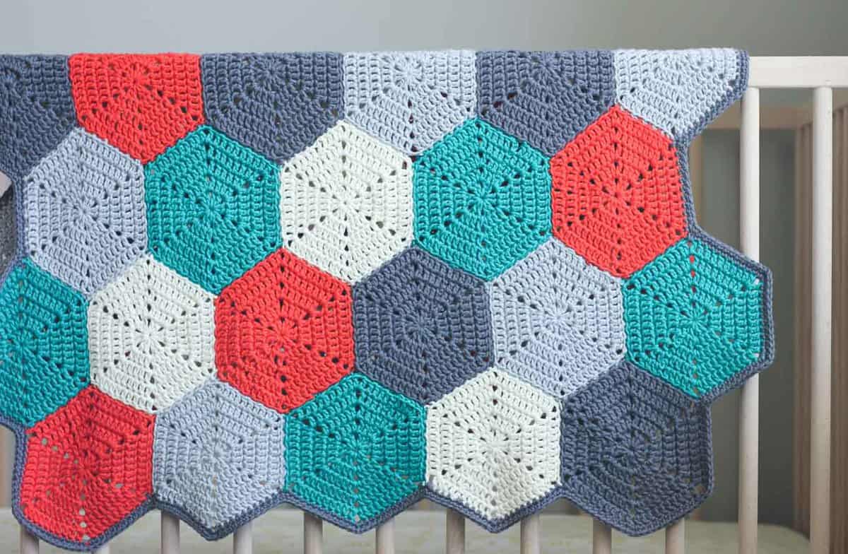 This free crochet afghan pattern is customizable, so you can use it to make a baby blanket, lap blanket or even a bedspread. Makes a great modern, gender-neutral baby shower gift idea or an afghan for the couch. Click for the free pattern and photo tutorial. | MakeAndDoCrew.com