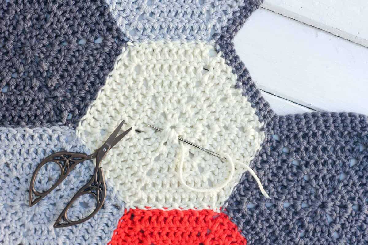 How to weave in crochet ends on hexagons or other pieces using a magic circle technique.
