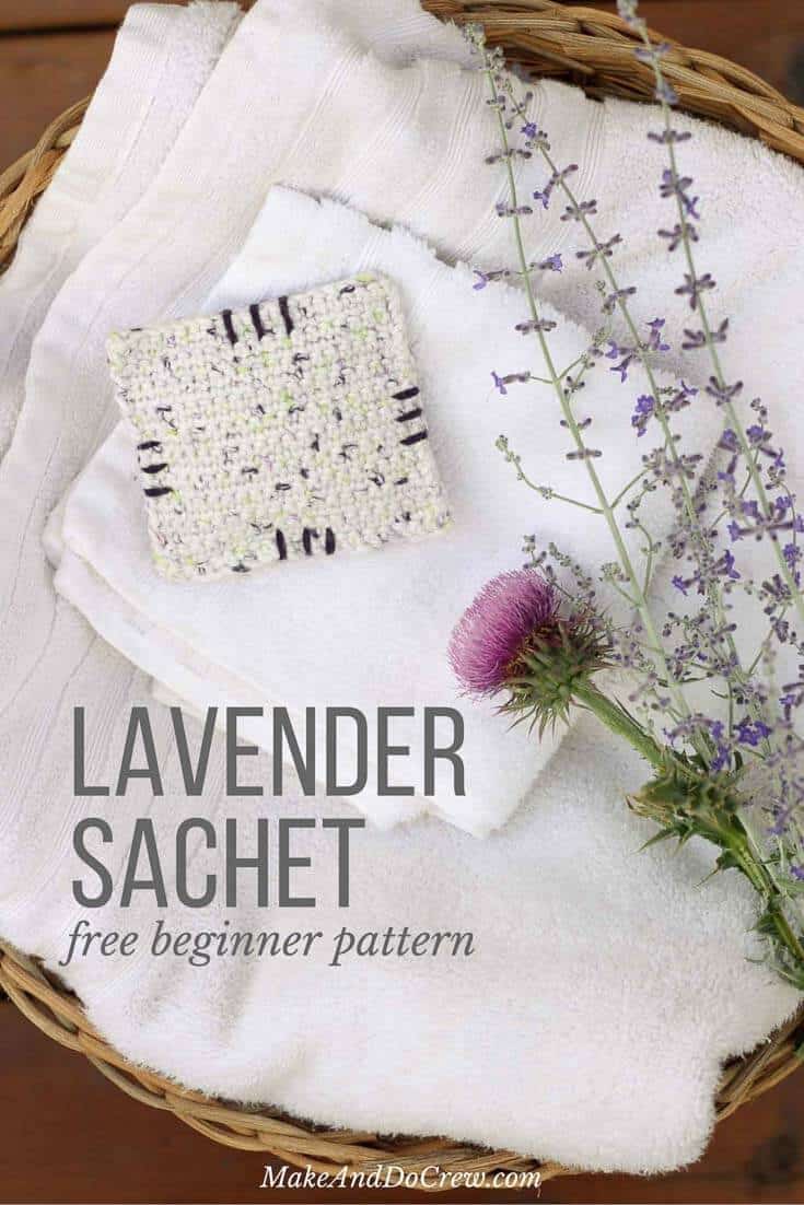 A crocheted lavender sachet sitting on a washcloth.