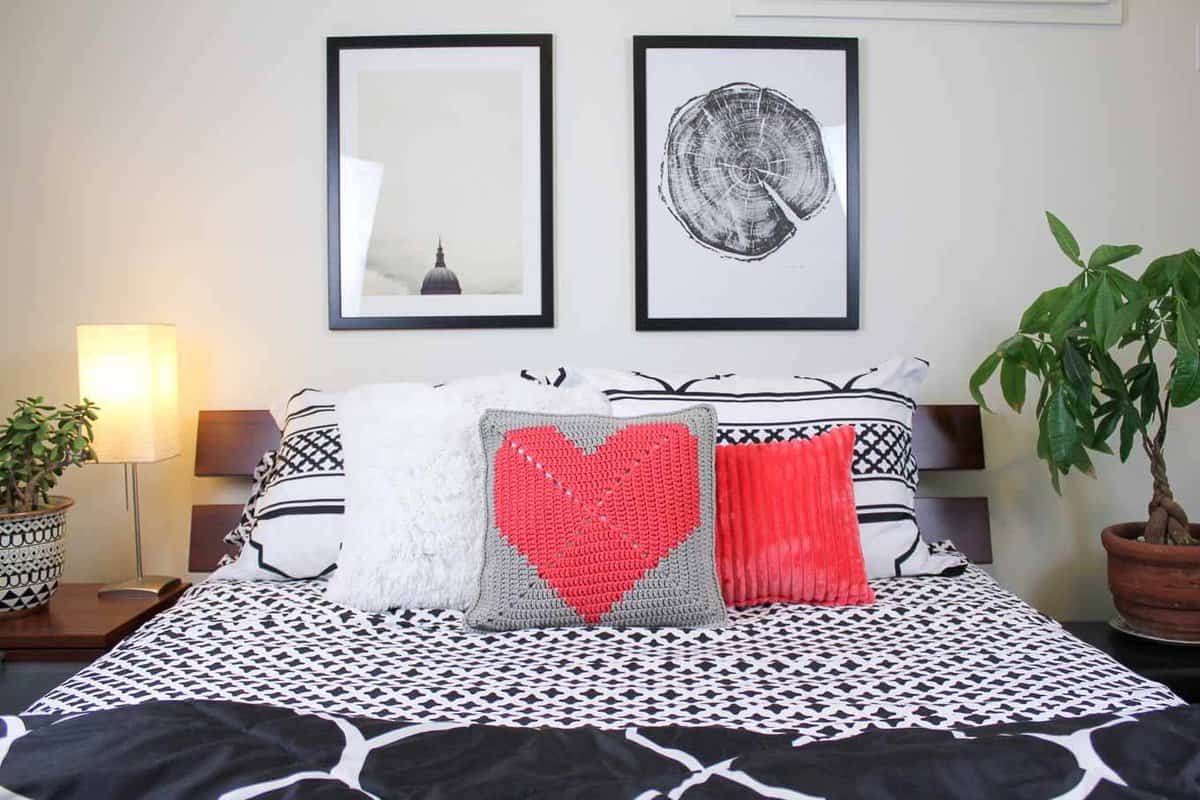 This free crochet pillow pattern with a modern heart makes a perfect DIY gift idea. Square cushion pattern includes written instructions, photo tutorial and a chart. | MakeAndDoCrew.com