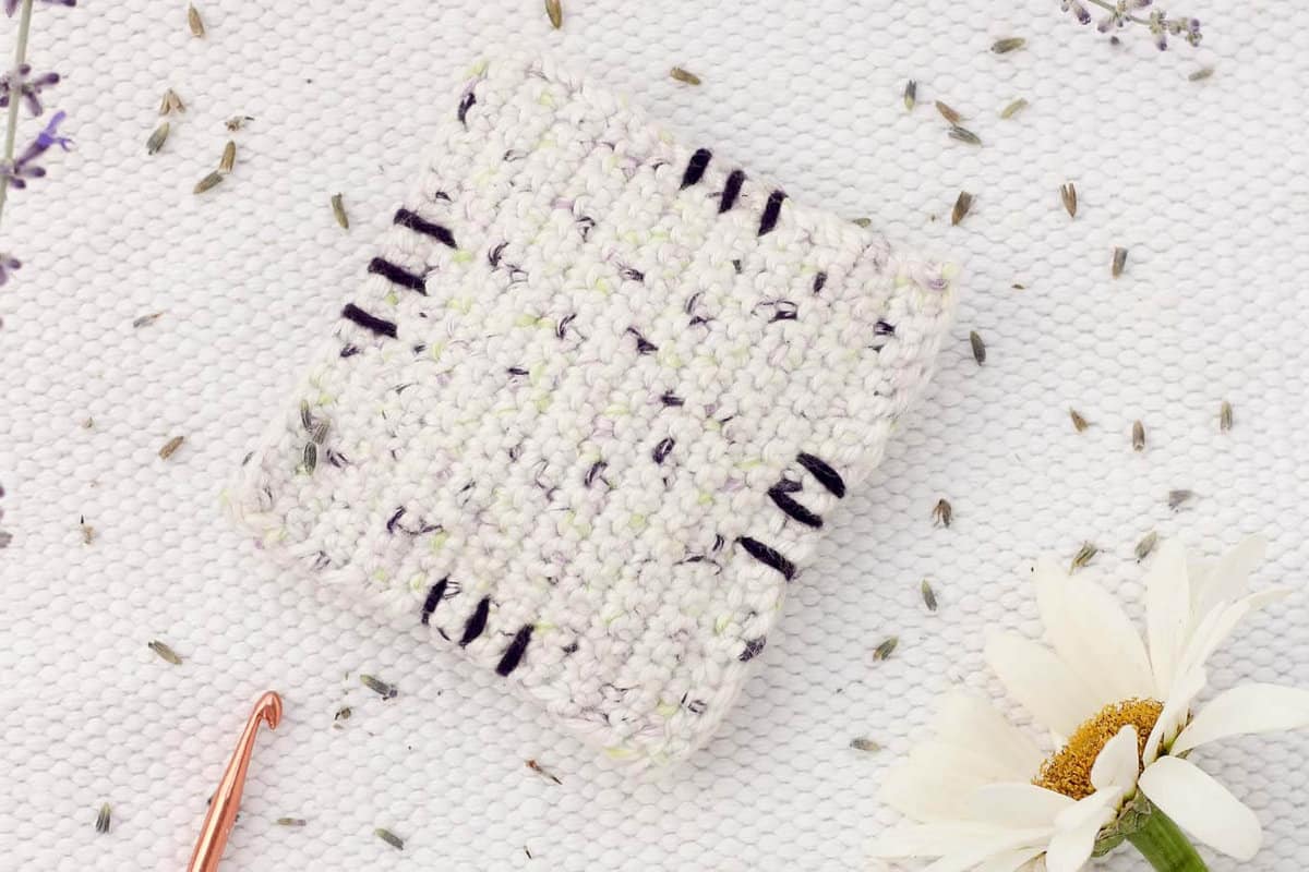 This free crochet pattern is perfect for beginners and a great way to use up dried lavender from your garden! Pop one of these crochet lavender sachets in the dryer and you've got natural and inexpensive way to keep your laundry smelling fresh! | MakeAndDoCrew.com