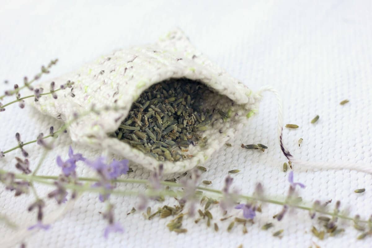 This free crochet pattern is perfect for beginners and a great way to use up dried lavender from your garden! Pop one of these crochet lavender sachets in the dryer and you've got natural and inexpensive way to keep your laundry smelling fresh! | MakeAndDoCrew.com