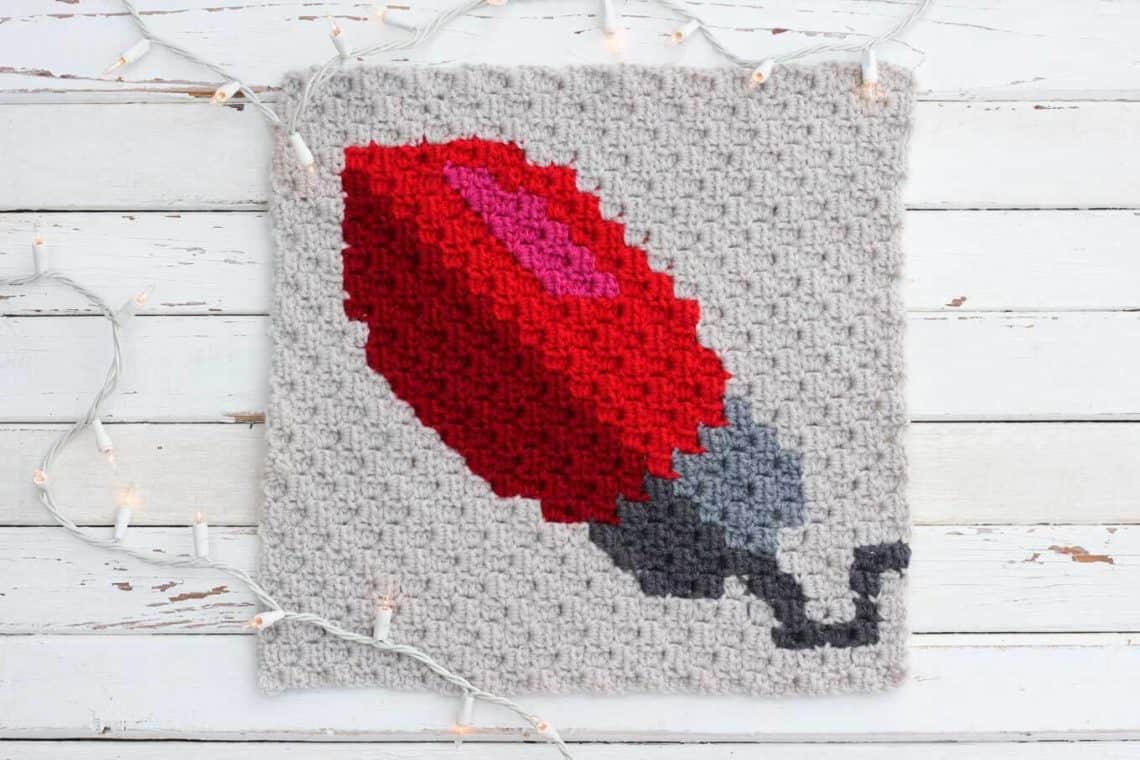 Crochet this free C2C Christmas light bulb graph to make a throw pillow or create several of these squares in different colors for a Christmas afghan. This free pattern is part of a 9 block modern Christmas afghan. Click for all the free corner to corner graphs! (Yarn is Lion Brand Vanna's Choice)