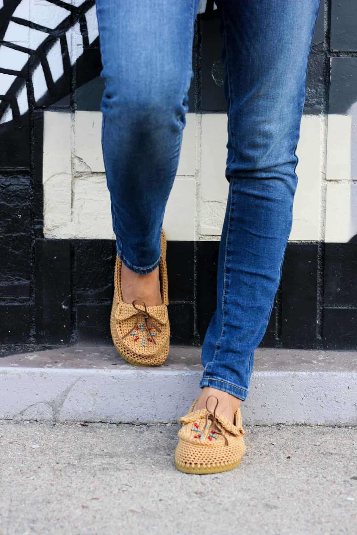 Learn how to crochet shoes with flip flop soles with this free crochet moccasin pattern and video tutorial! These crochet moccasins make super comfortable women's shoes or slippers and can be customized however you wish. Made from Lion Brand 24/7 Cotton in "Camel" color. Seed beads add the perfect boho touch! 