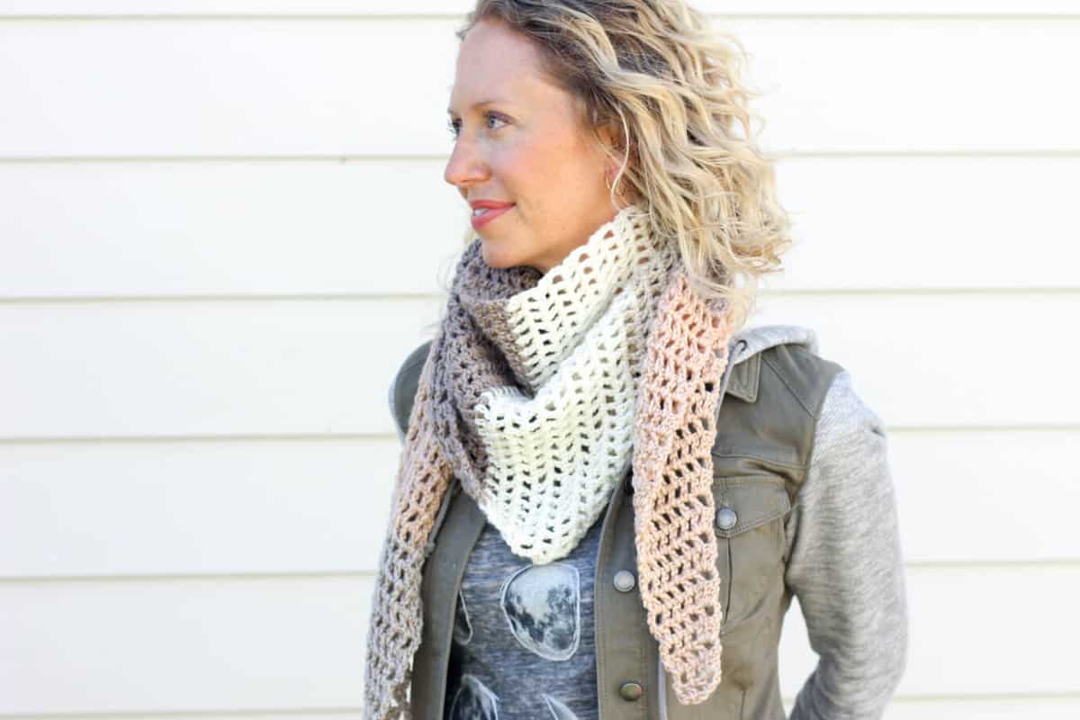 Toss on this modern crochet triangle scarf to head out to the desert, the mountains...or just the grocery store. This free Caron Cakes crochet pattern takes all the stress out of choosing colors because the skein does it for you! Color = Buttercream. 