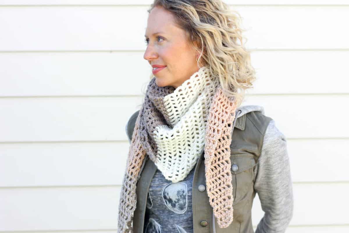 Toss on this modern crochet triangle scarf to head out to the desert, the mountains...or just the grocery store. This free Caron Cakes crochet pattern takes all the stress out of choosing colors because the skein does it for you! Color = Buttercream.