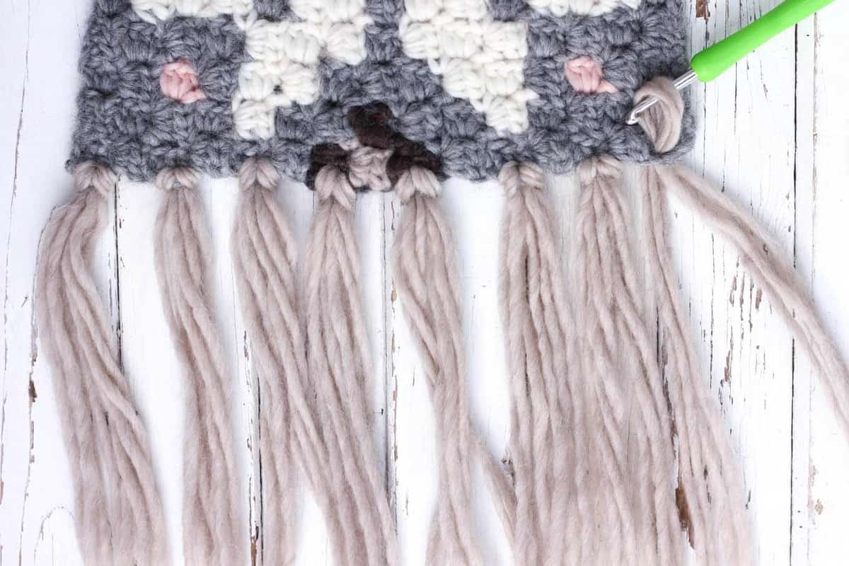 Simple tutorial for how to add fringe to a crocheted scarf using Patons Classic Wool Roving yarn. 