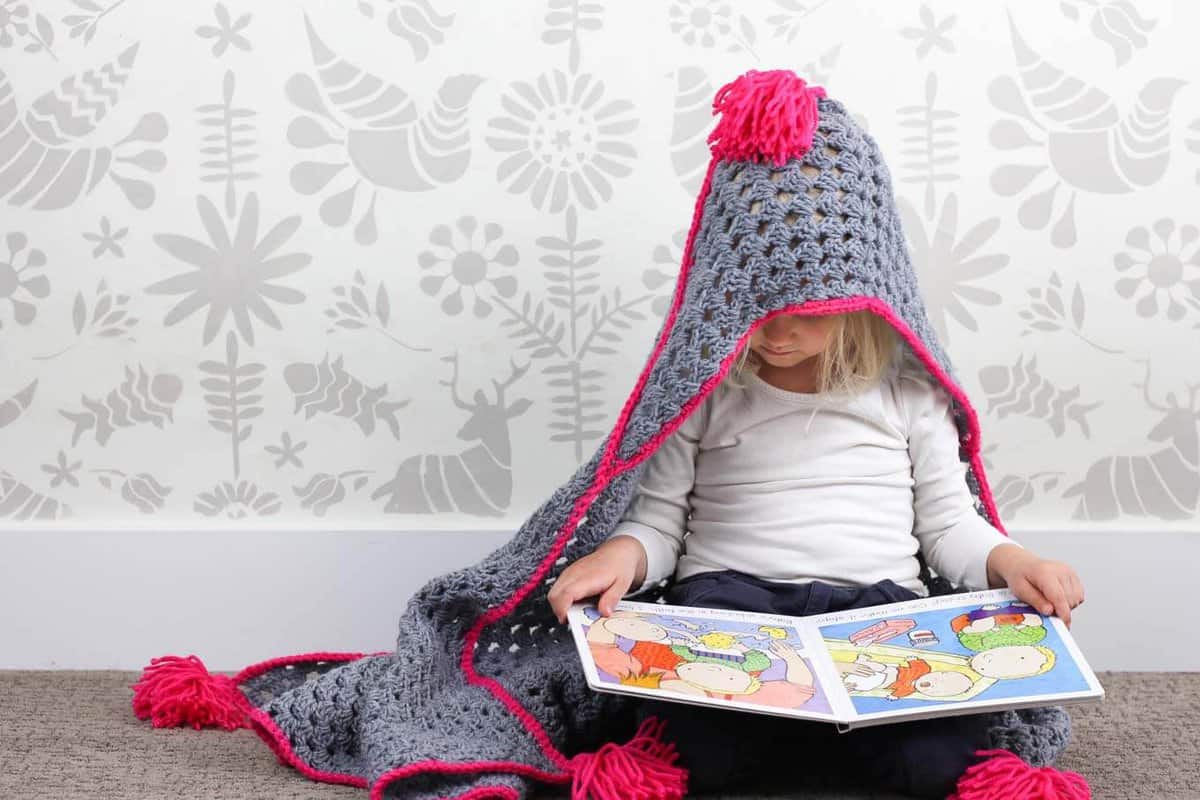 Based on a large granny square, the "Granny Gives Back" crochet hooded baby afghan pattern makes an easy and inexpensive project to donate to children's charities. The oversized hood and playful tassels will give any kid a safe, warm place to escape to. Click for the free pattern using Lion Brand Pound of Love yarn!