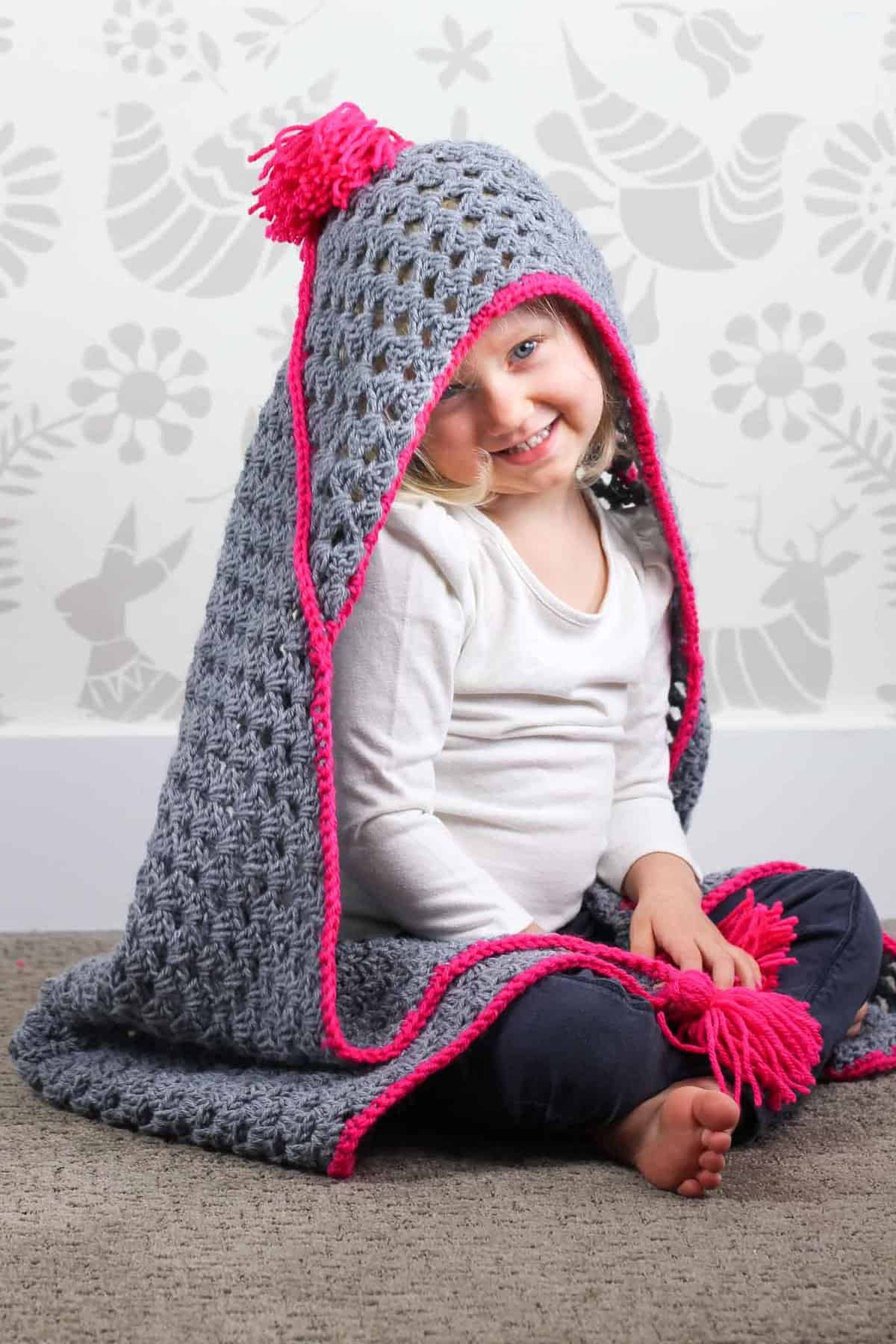 Based on a large granny square, the "Granny Gives Back" crochet hooded baby blanket pattern makes an easy and inexpensive project to donate to children's charities. The oversized hood and playful tassels will give any kid a safe, warm place to escape to. Click for the free pattern using Lion Brand Pound of Love yarn!