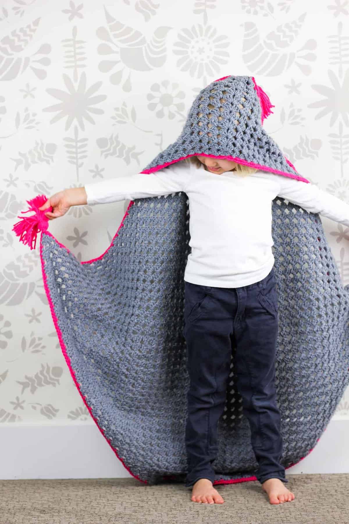 Based on a large granny square, the "Granny Gives Back" crochet hooded blanket pattern makes an easy and inexpensive project to donate to children's charities. The oversized hood and playful tassels will give any kid a safe, warm place to escape to. Click for the free pattern using Lion Brand Pound of Love yarn!